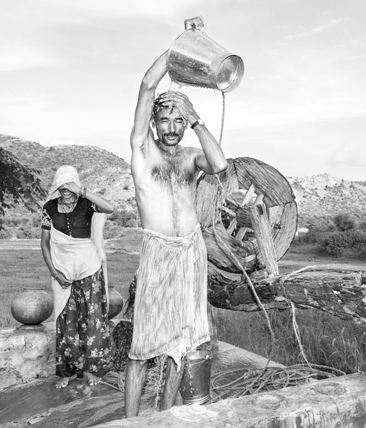 Men and Water Needs from Gender Perspective - Enjoying a bath at a rejuvenated well  in Alwar district, Rajasthan